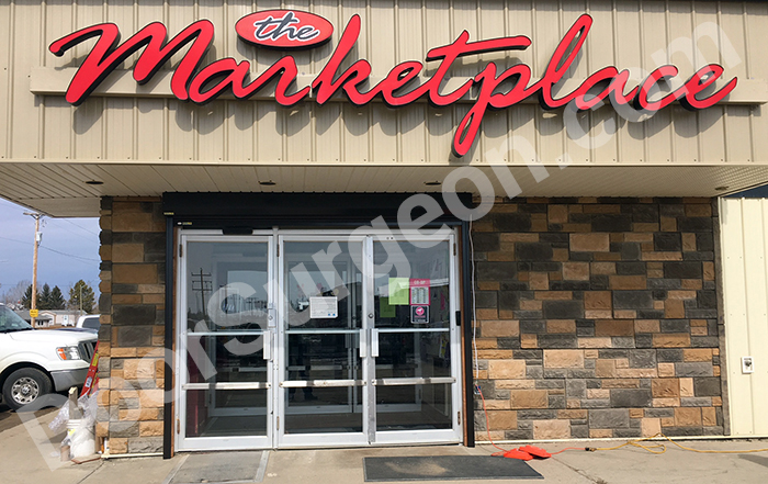 Roll shutter commercial storefront door entrance protection rolled up.